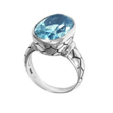 Handcrafted sterling silver ring with oval Blue Topaz Quartz and artisan carved band, made in Bali